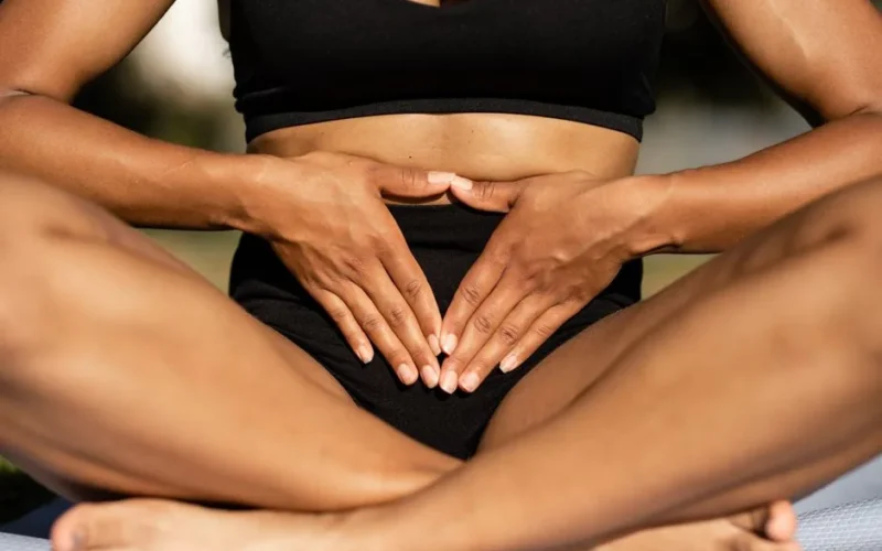 A person practicing mindfulness and balance through yoga with a focus on the core.