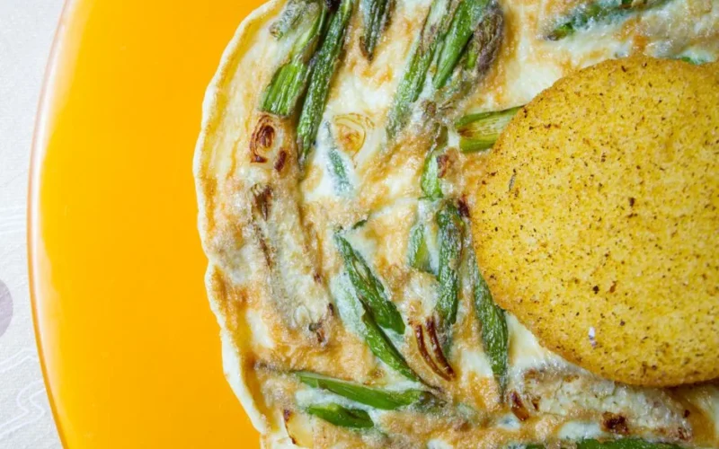 Close-up of a delicious asparagus frittata paired with cornbread, a perfect breakfast choice.