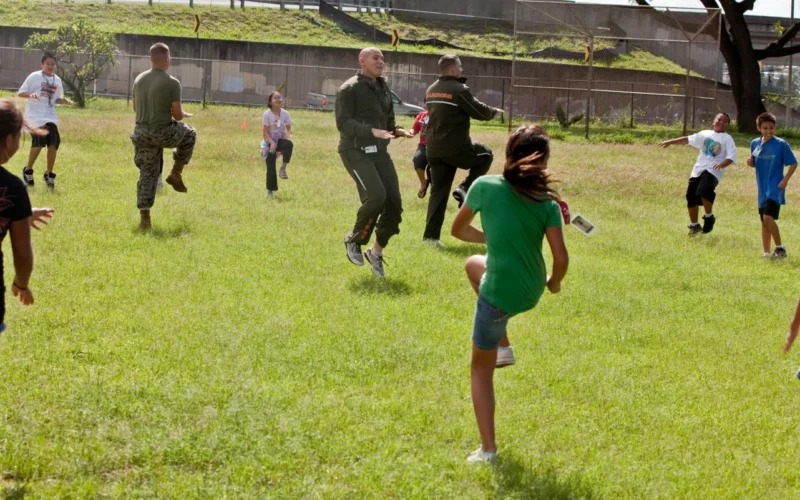 Volunteers with U. S. Marine Corps Forces, Pacific lead Aiea Elementary School students in warm-up exercises March 8 at the school, here. MarForPac Marines assisted the school’s physical education teacher with her classes as part of the command’s ongoing community service efforts. MarForPac officials plan to continue volunteering at numerous schools around the community.