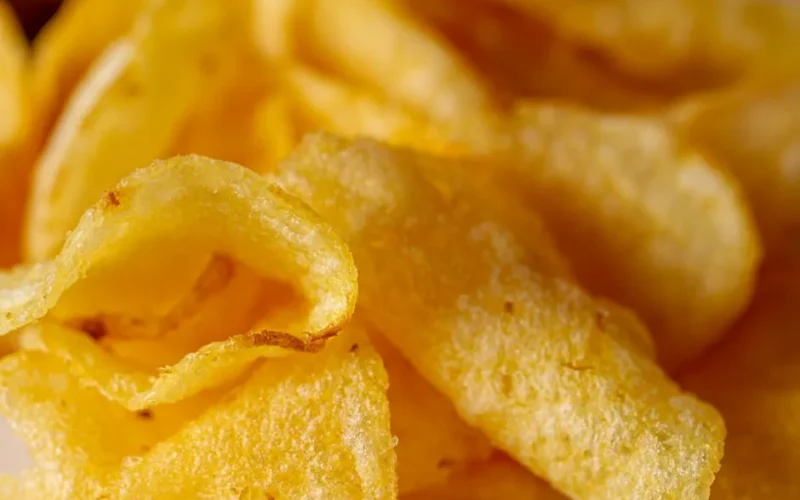 Delicious close-up of crispy golden potato chips, perfect snack option.