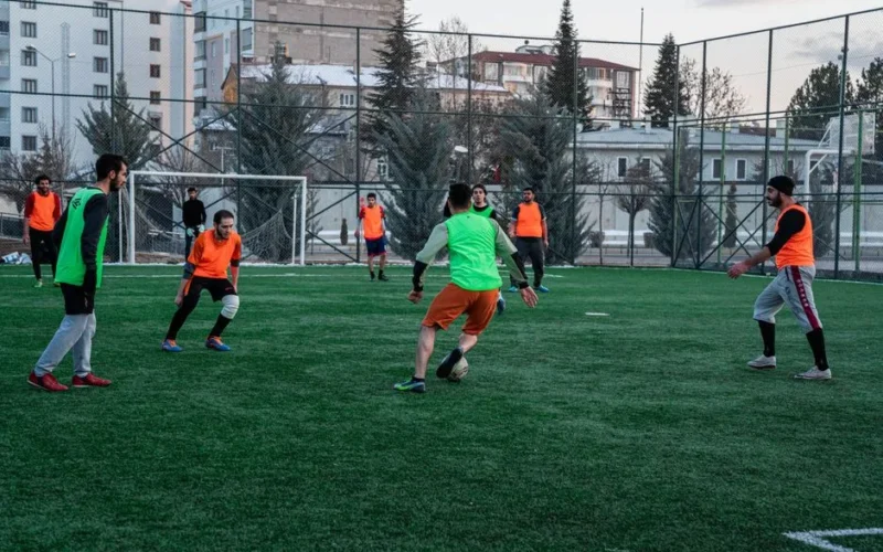 Casual soccer game on an outdoor field in İstanbul, Türkiye, showcasing teamwork and sportsmanship.