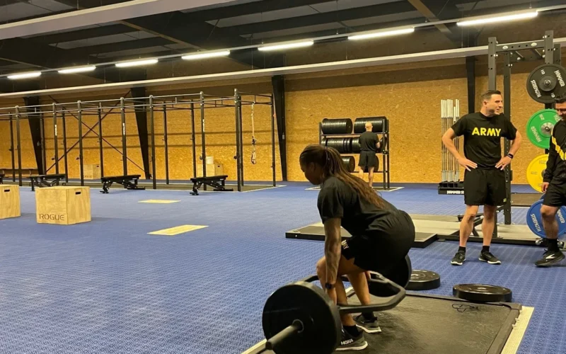 Soldiers from Headquarters and Headquarters Company (HHC), U.S. Army Garrison Rheinland-Pfalz, conducted the Army Combat Fitness Test (ACFT) using the recently upgraded Functional Fitness Training Center (FFTC) on Rhine Ordnance Barracks (ROB) Aug. 9. Staff Sgt. Francesca Cyma, Supply Specialist for HHC Rheinland-Pfalz performs the 3 Repetition Maximum Deadlift (MDL) event. The MDL assesses the muscular strength component of fitness by measuring a Soldier’s lower body, grip and core muscular strength. It requires well-conditioned back and leg muscles and helps Soldiers avoid hip, knee and lower back injuries. Flexibility and balance are secondary components of fitness assessed by the MDL. (Photo by Gabriela Montanez)