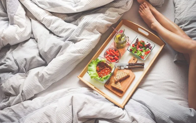 Enjoy a delightful morning with a healthy breakfast on a wooden tray, perfect for a relaxing start to the day.